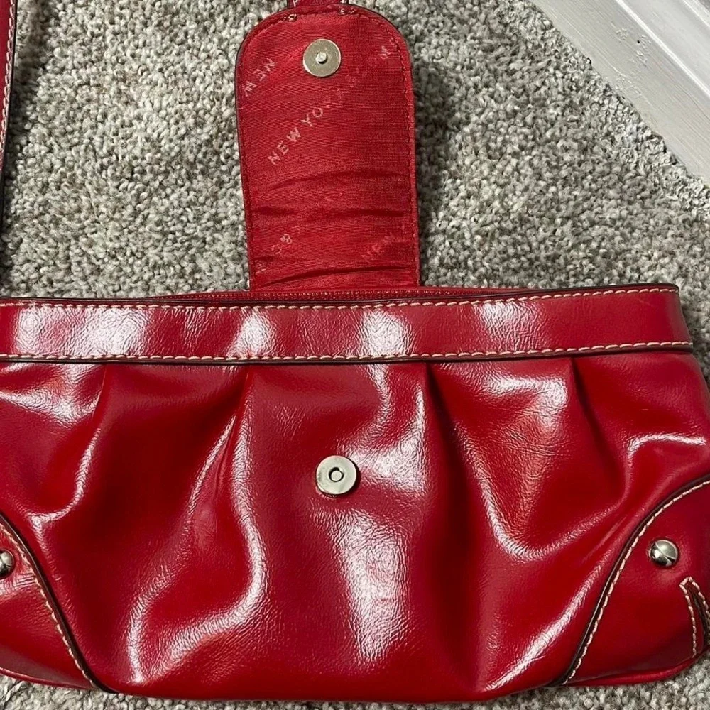 Red leather clutch handbag with silver hardware